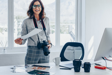 Young woman photographer at her office