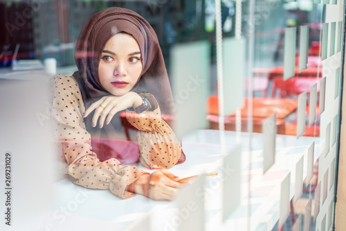 Young Asian Muslim Business Woman In Brown Hijab Casual Wear