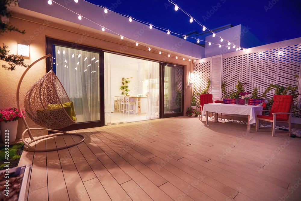 evening patio area with open space kitchen and sliding doors - obrazy, fototapety, plakaty 