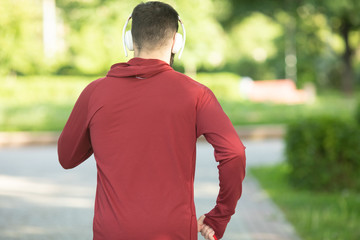 Wall Mural - Male runner running on road training for fitness. Man doing jogging workout run outside in summer in nature