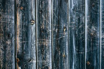 Wall, fence made of wooden boards with an interesting pattern and structure of wood.