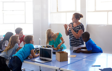 Wall Mural - Students In After School Computer Coding Class Building And Learning To Program Robot Vehicle