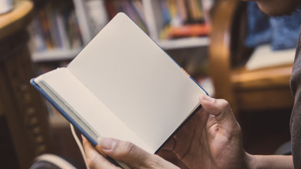 Man reading Book in his hands.