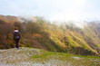 © Alessia - girl walks alone in the mist and fog along the paths of the Apuan Alps in Tuscany