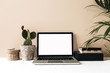 © Floral Deco - Minimalist home office desk workspace with laptop, cactus and palm on beige background. Front view copy space blank mock up. Blog, website, social media hero header template.