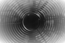 Black And White Picture Of Metal Electric Fan , Air Conditioner With Moving Blades And Vignette Frame.