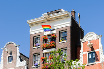 A canal house flies a rainbow flag for Gay Pride