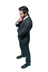 Wall Mural - Confident businessman posing with hand on chin