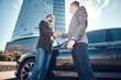 © Fxquadro - Low angle photo of two smart elegant men, which have a deal about car. They are doing handshake.
