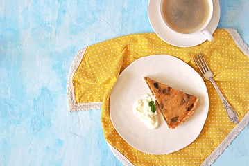 Wall Mural - A portion of pumpkin pie with prunes on a white plate on a light blue background. Top view