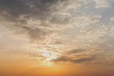 Fototapeta Desenie - sunlight from sunset illuminates the cloudy sky