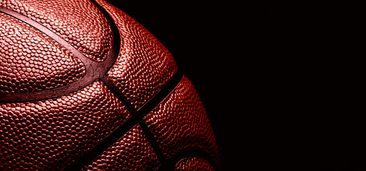 Wall Mural - basketball ball on black background.