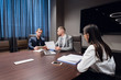© romankosolapov - Coworkers meeting at conference room to discuss project in office