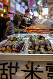 Fototapeta Na drzwi - Korean-style gimbap (also known as 'kimbap') sushi rolls for sale among diners at lunch time in the famous, crowded Gwangjang Market in Seoul