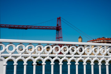 Wall Mural - Recently painted white fence with the Transporter bridge called Vizcaya Bridge  (Puente transportador de Vizcaya)