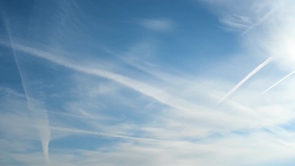 Wall Mural - Day to night time-lapse of clouds and vapor trails moving through the sky