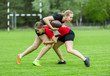 © Augustas Cetkauskas - Girls playing american football together outside in summer