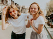 © halayalex - Portrait of two young beautiful blond smiling hipster girls in trendy summer white t-shirt clothes. Sexy carefree women posing on street background. Positive models having fun.Hugging