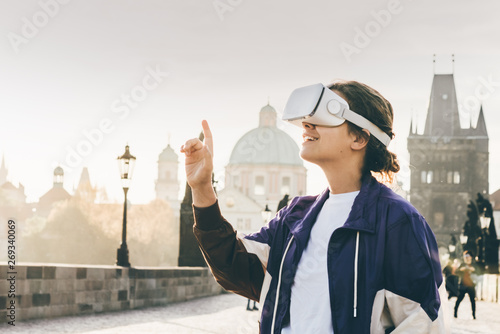 Woman wearing vr headset augmented virtual reality in history city center. Concept of virtual museum.