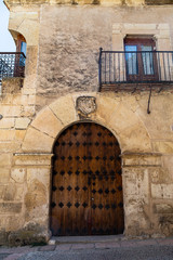 Wall Mural - Pedraza, Castilla Y Leon, Spain: reinforced iron doorway with heraldic crest above. Pedraza is one of the best preserved medieval villages of Spain, not far from Segovia