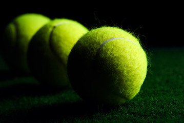 Wall Mural - Tennis Ball isolated on black with dramatic lighting