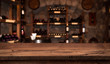Defocused dark wine cellar background with wooden table in front