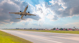 Fototapeta  - White passenger airplane in the clouds -  Airplane take off from the  airport    - Travel by air transport