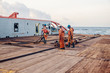 © Igor Kardasov - Anchor-handling Tug Supply AHTS vessel crew preparing vessel for static tow tanker lifting. Ocean tug job. AB and Bosun on deck. They pull towing wire