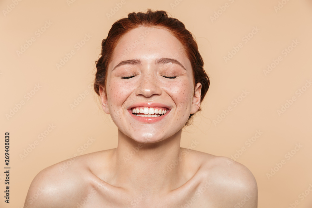 Amazing young redhead woman posing isolated over beige wall background. - obrazy, fototapety, plakaty 