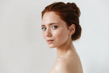 Young Redhead Woman Posing Isolated Over White Wall Background.