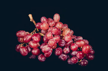 Red grape isolated on black Background.