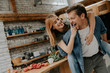 © BGStock72 - Lovely couple having fun together at rustic kitchen