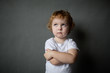 © polya_olya - Offended little boy , on gray background