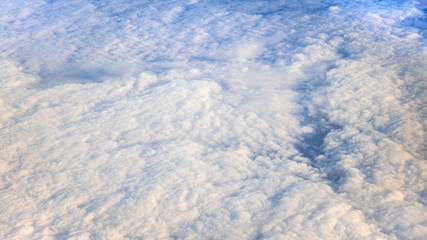 Wall Mural - The beautiful cloudscape with clear blue sky. A view from airplane window.