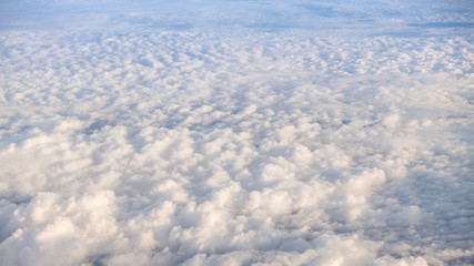 Wall Mural - The beautiful cloudscape with clear blue sky. A view from airplane window.