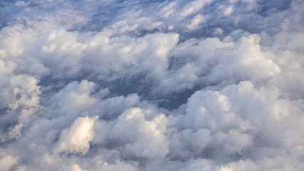 Wall Mural - The beautiful cloudscape with clear blue sky. A view from airplane window.