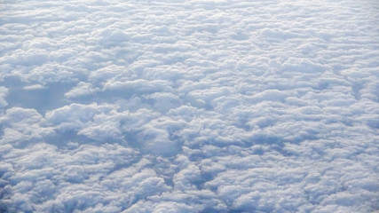 Wall Mural - The beautiful cloudscape with clear blue sky. A view from airplane window.