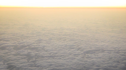 Wall Mural - Aerial traveling. Flying at dusk or dawn. Fly through orange cloud and sun.