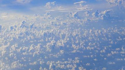 Wall Mural - The beautiful cloudscape with clear blue sky. A view from airplane window.