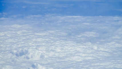 Wall Mural - The beautiful cloudscape with clear blue sky. A view from airplane window.