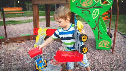 little boy with truck and trailer