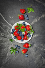 Wall Mural - Fresh berries strawberries and blueberries with leaves and flower