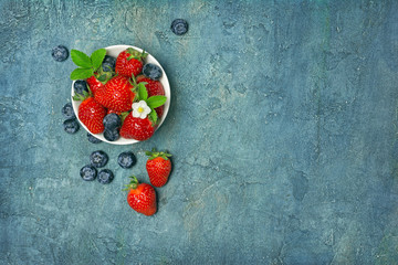 Wall Mural - Fresh berries strawberries and blueberries with leaves and flower