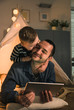 © Westend61 - Son kissing his father at home