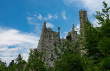 Fototapeta  - Breathtaking rocky formations tower above the vibrant greenery in French Alps.