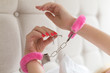Pink sexy fluffy handcuff on female wrists