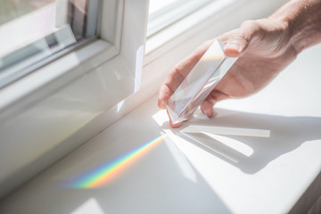 Transprent prism for physics educational experiments in a man's hand