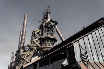 Wall Mural - Monumental view, smokestacks and blast furnaces of steel mill industrial site, horizontal aspect