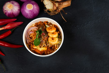 Poster -  Malaysian Assam Laksa on a dark wooden table with ingredients spread on the table