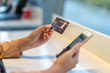 © THANANIT - Closeup Asian woman using credit card with mobile for online shopping in department store over the clothes shop store background, technology money wallet and online payment concept, credit card mockup